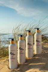 Rad Spa products on beach, body cream, shampoo., conditioner, shower gel